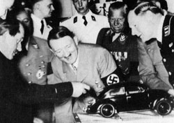 Hitler examining a model of the first Volkswagen
